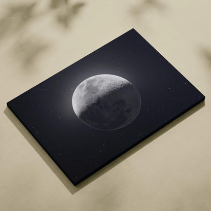 Black canvas print of half-lit moon in starry gray midnight blue sky