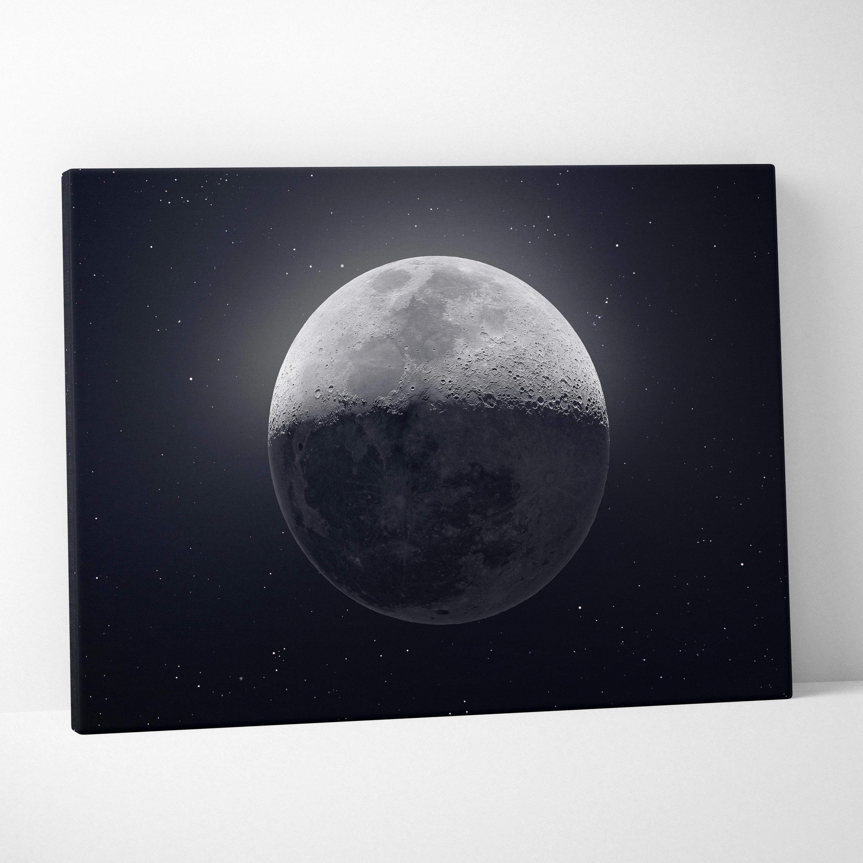 Black canvas print of half-lit grayscale moon in starry midnight blue sky