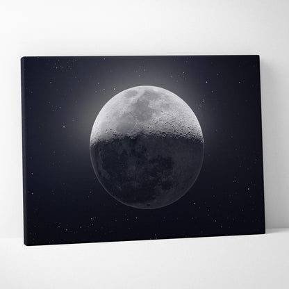 Black canvas print of half-lit grayscale moon in starry midnight blue sky