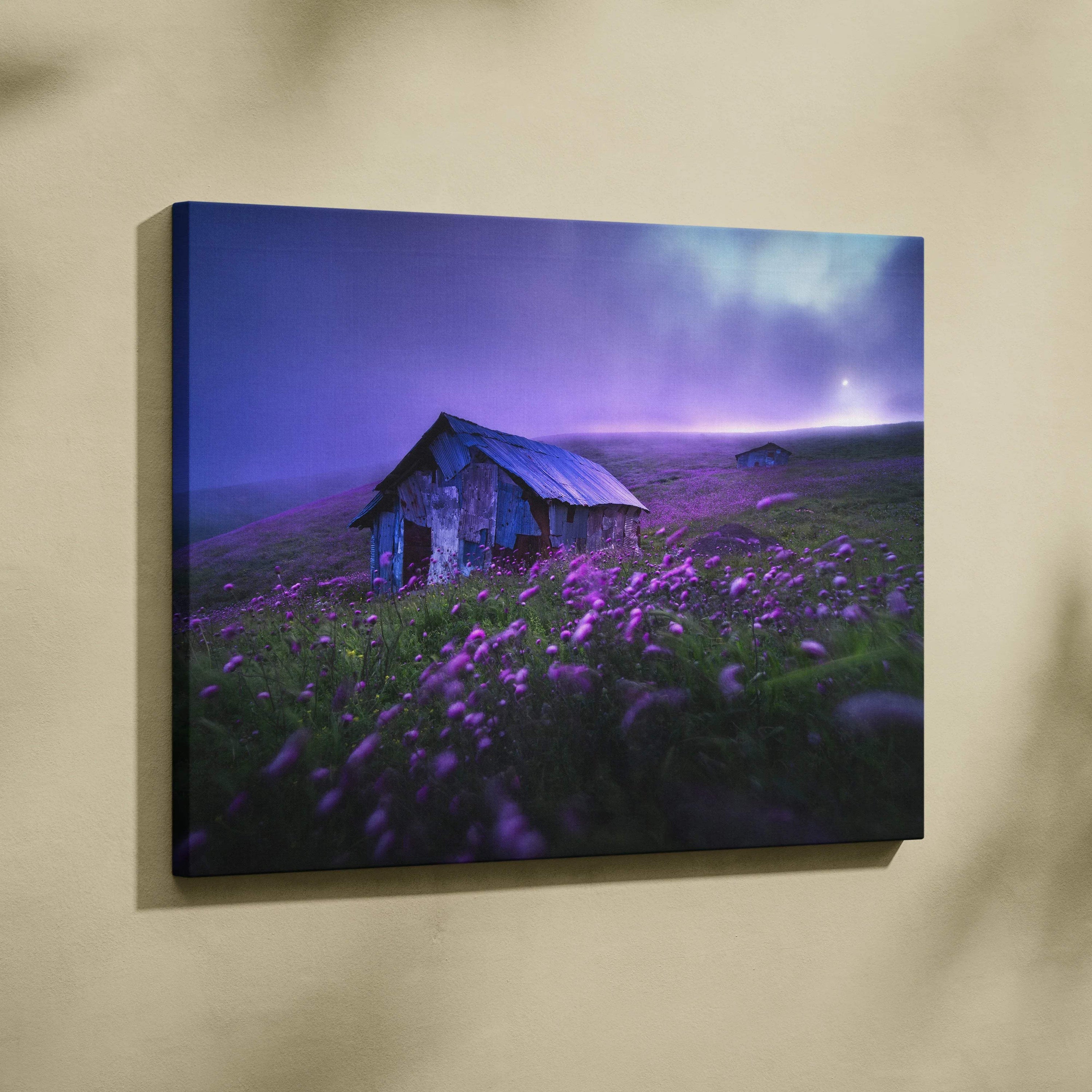 Weathered rustic cabin in misty purple wildflower meadow, moody twilight sky canvas print