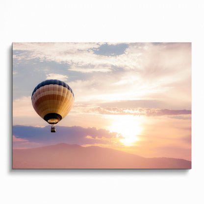 Sunset wall art poster featuring a hot air balloon floating over soft pastel clouds and mountains.