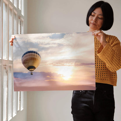 Sunset wall art poster with warm sky colors and a hot air balloon floating above clouds.