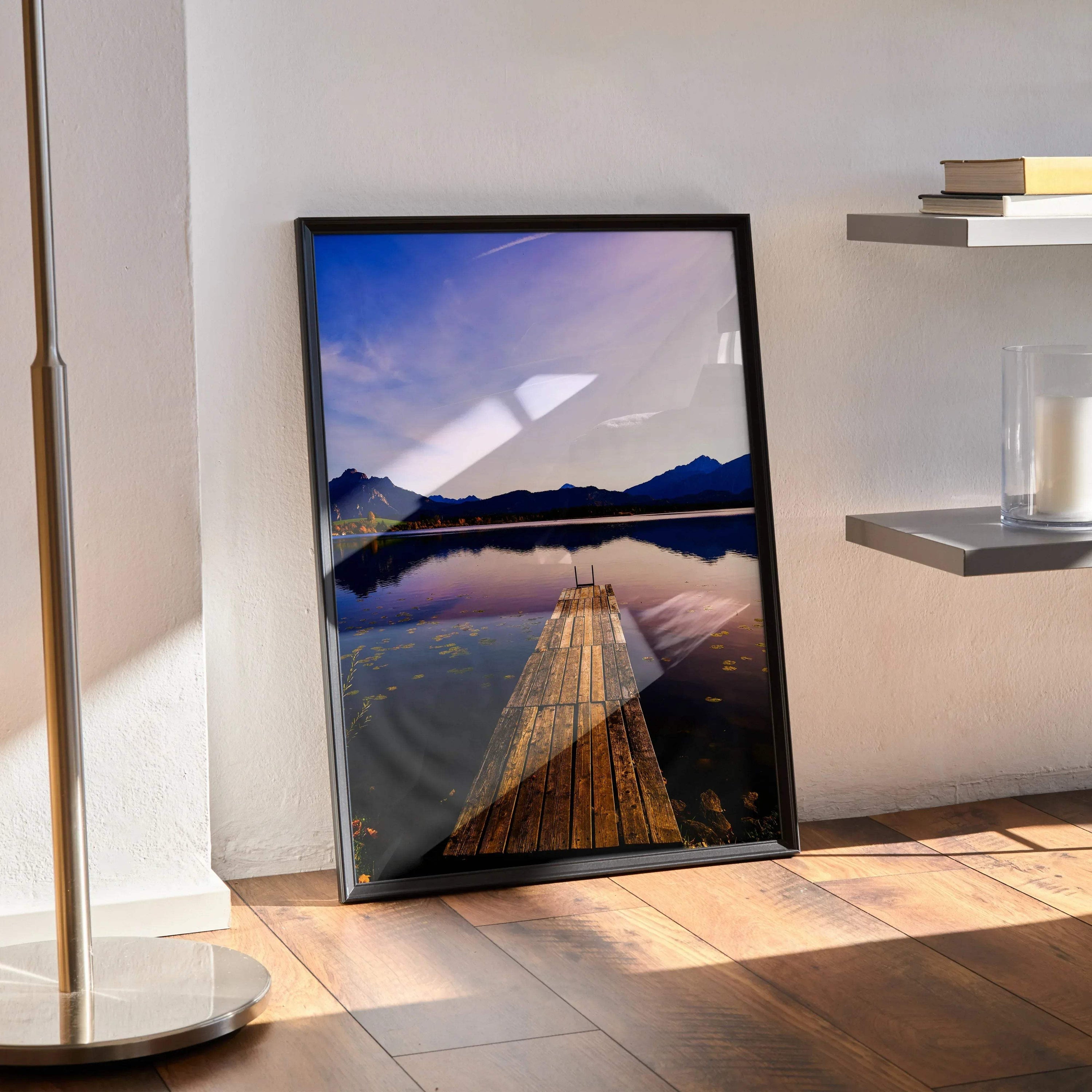 Sunset over mountain range reflected in lake with wooden pier, vertical wall art poster.