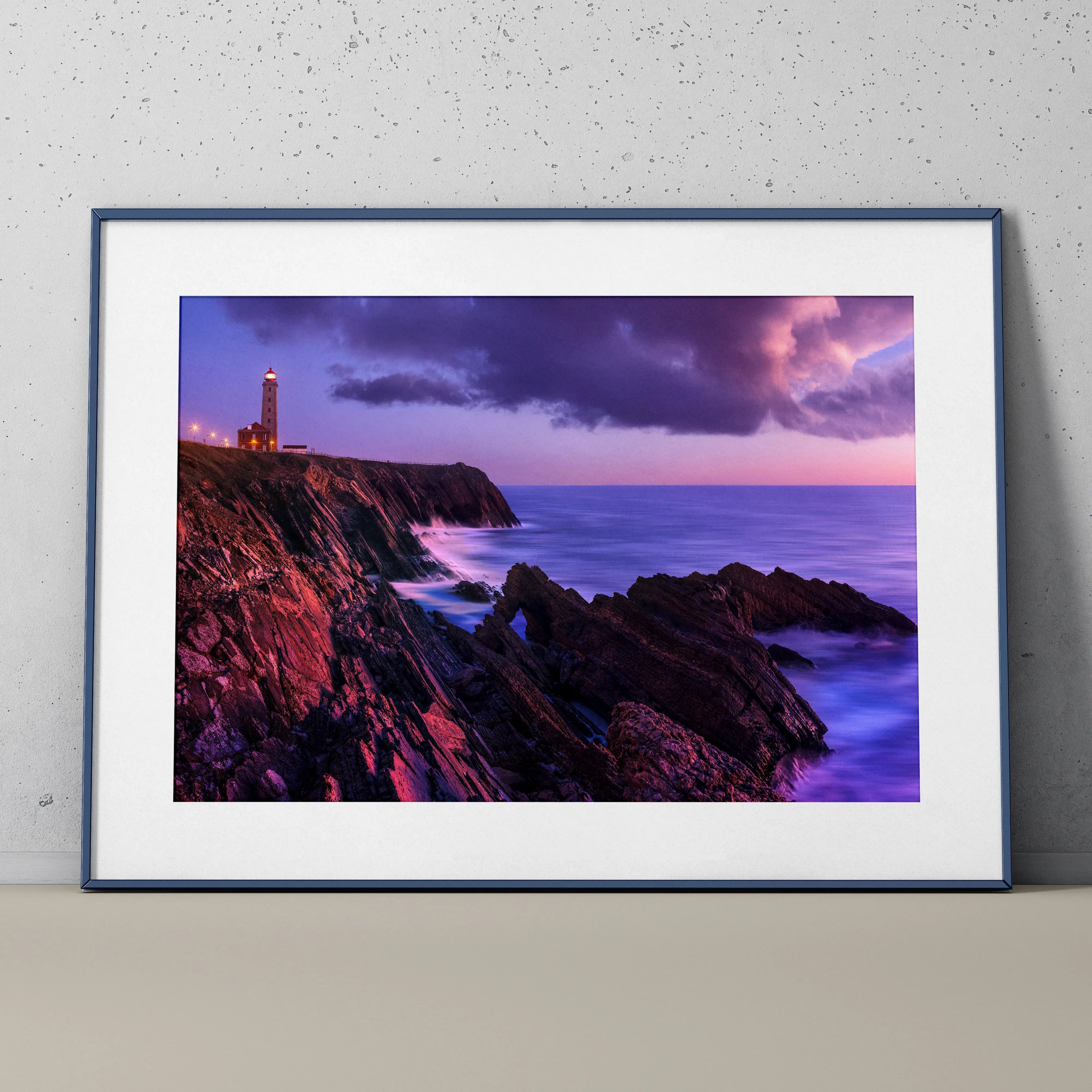 Sunset lighthouse poster with purple skies over rocky ocean cliffs, framed wall art.