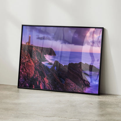 Sunset lighthouse on rocky coast ocean wall art poster with purple and pink sky tones.