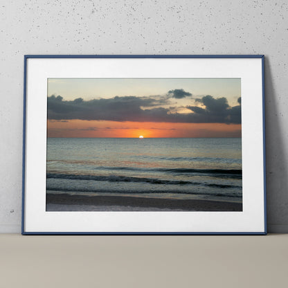 Beach sunset poster featuring calm ocean waves and colorful sky, framed wall art for nature decor.
