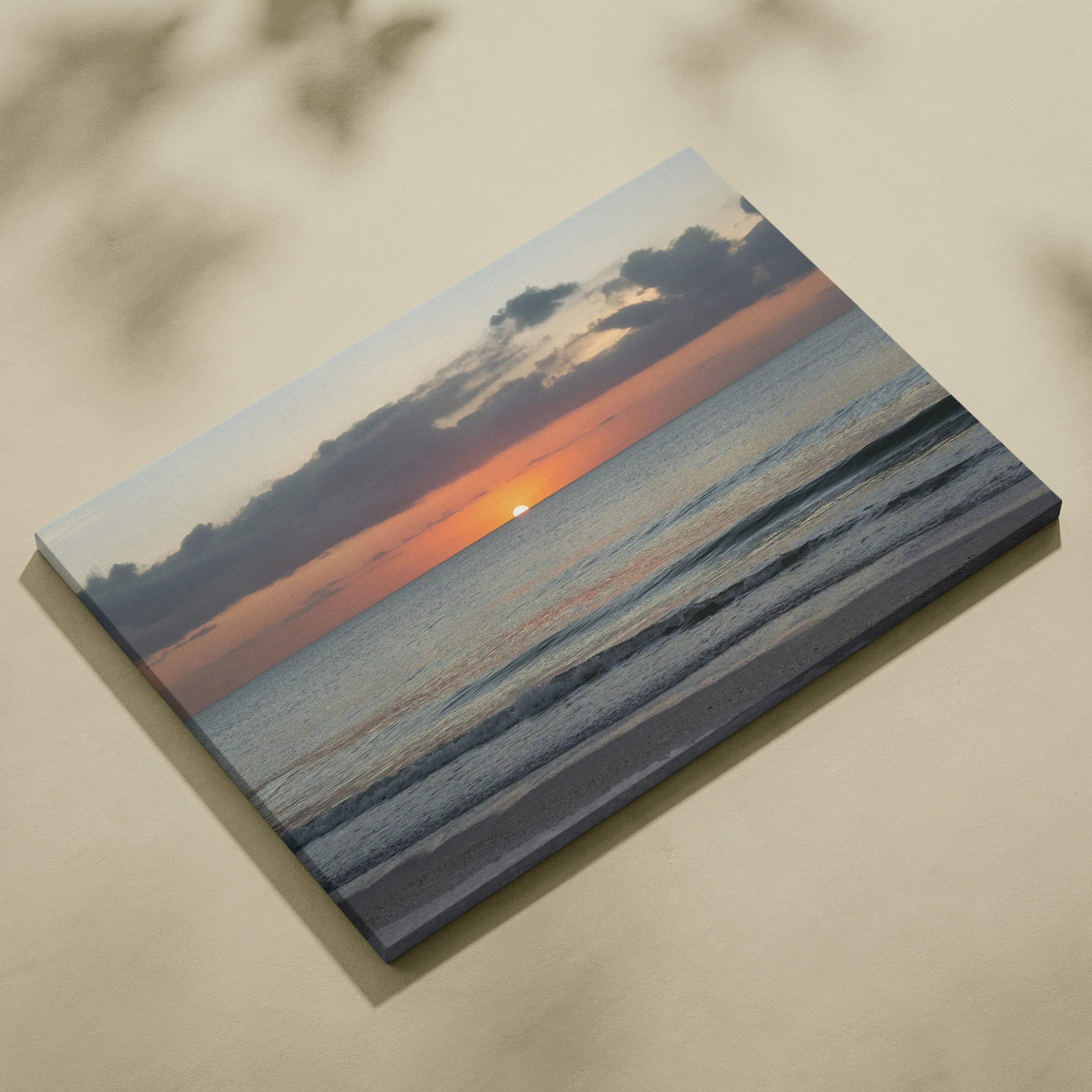 Sunset over calm ocean waves on vibrant canvas wall art with soft clouds and horizon silhouette.