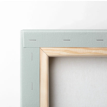 Close-up of wooden frame and white canvas texture showcasing wall art craftsmanship.
