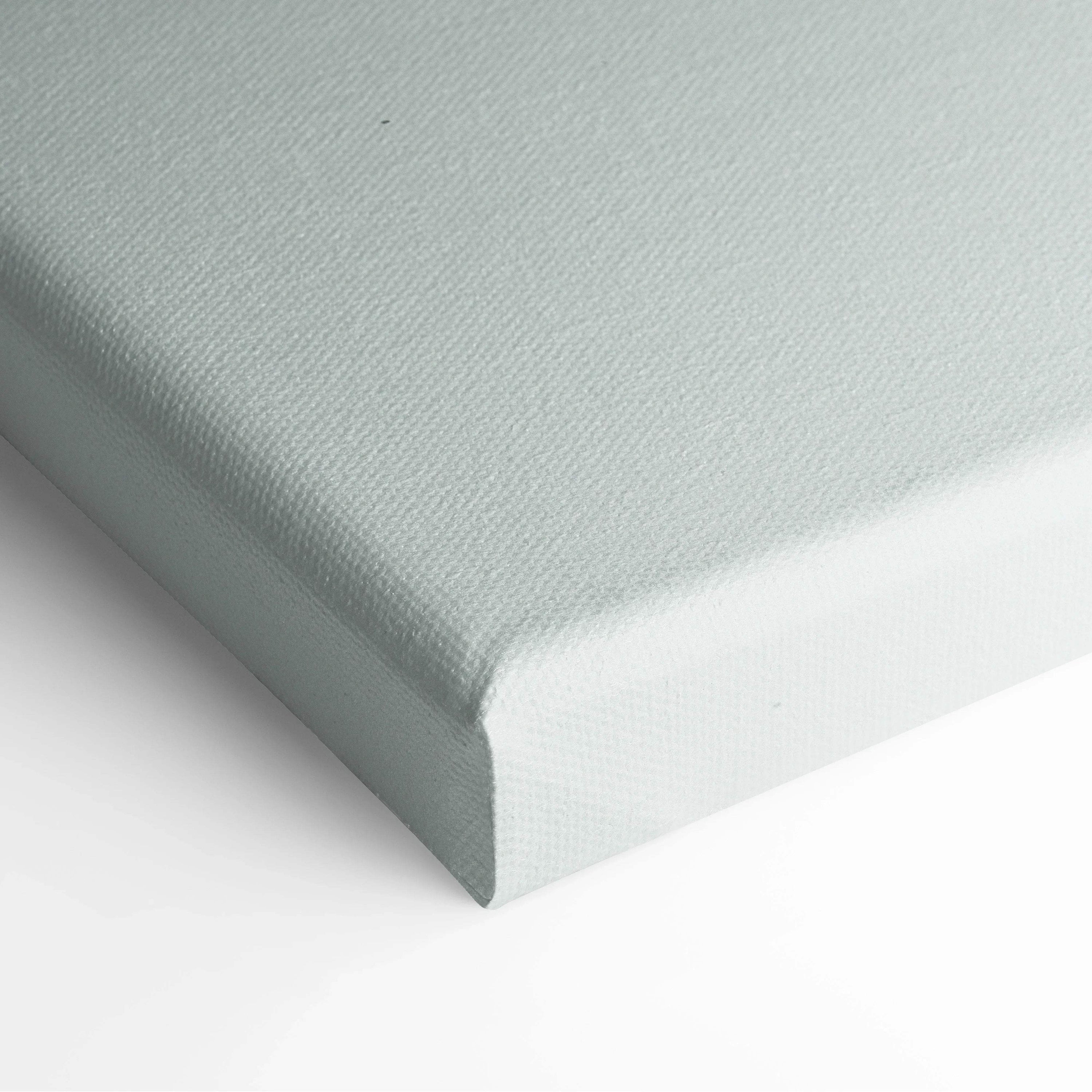 Close-up of blank light gray canvas stretched over wooden frame for wall art display.