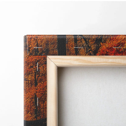 Close-up of vibrant autumn forest canvas wall art corner with detailed wood frame and rich orange foliage.