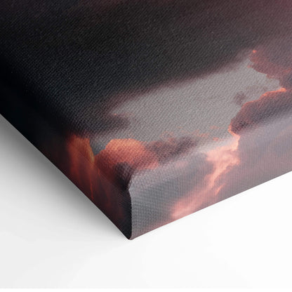 Canvas wall art featuring a vibrant sunset sky with dark clouds and glowing orange highlights.