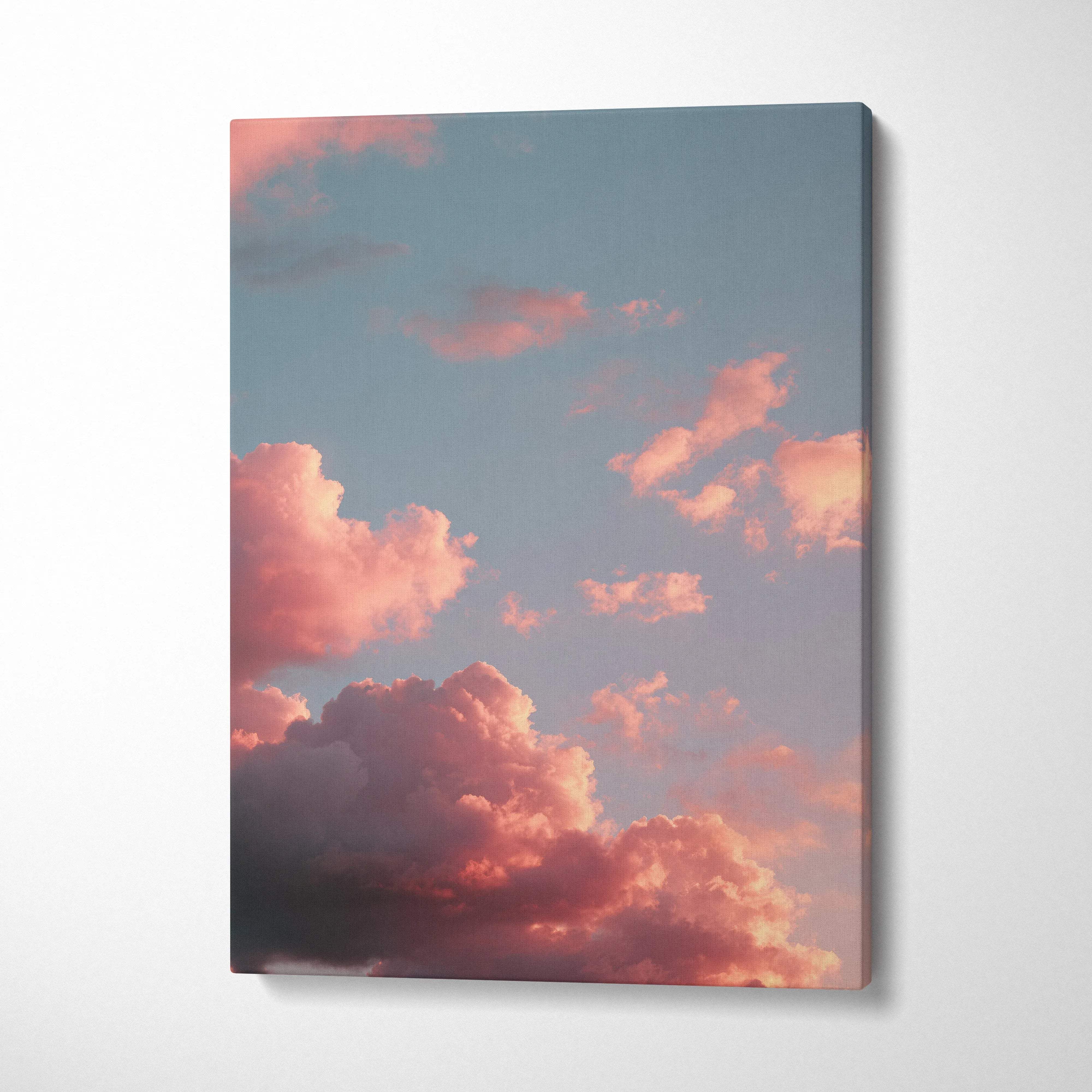 Vertical canvas wall art featuring vibrant sunset clouds against a soft blue sky.