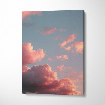 Vertical canvas wall art featuring vibrant sunset clouds against a soft blue sky.