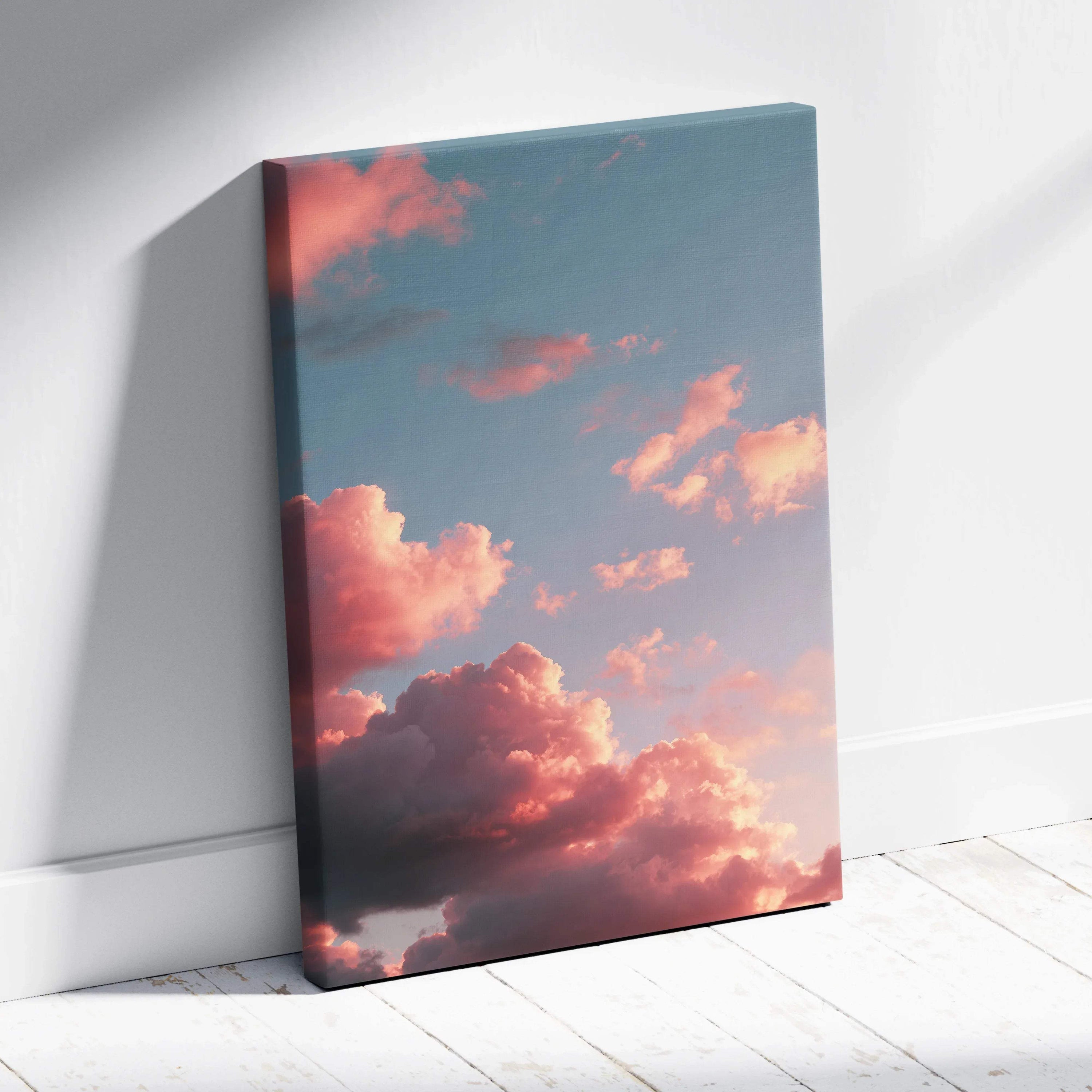 Canvas wall art featuring vibrant sunset clouds in warm pink and orange hues against a soft blue sky.