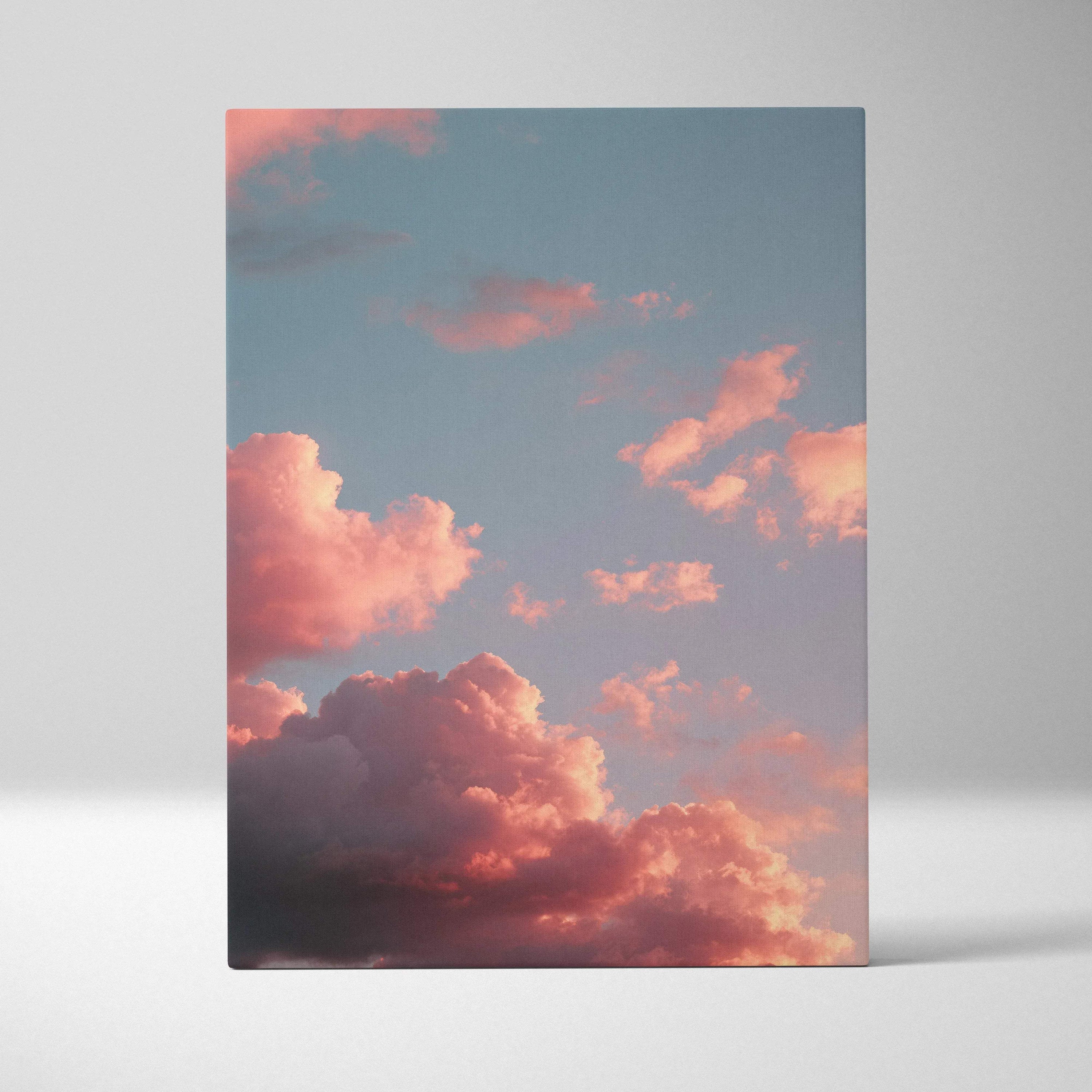 Vertical canvas wall art featuring vibrant pink and orange sunset clouds against a blue sky.