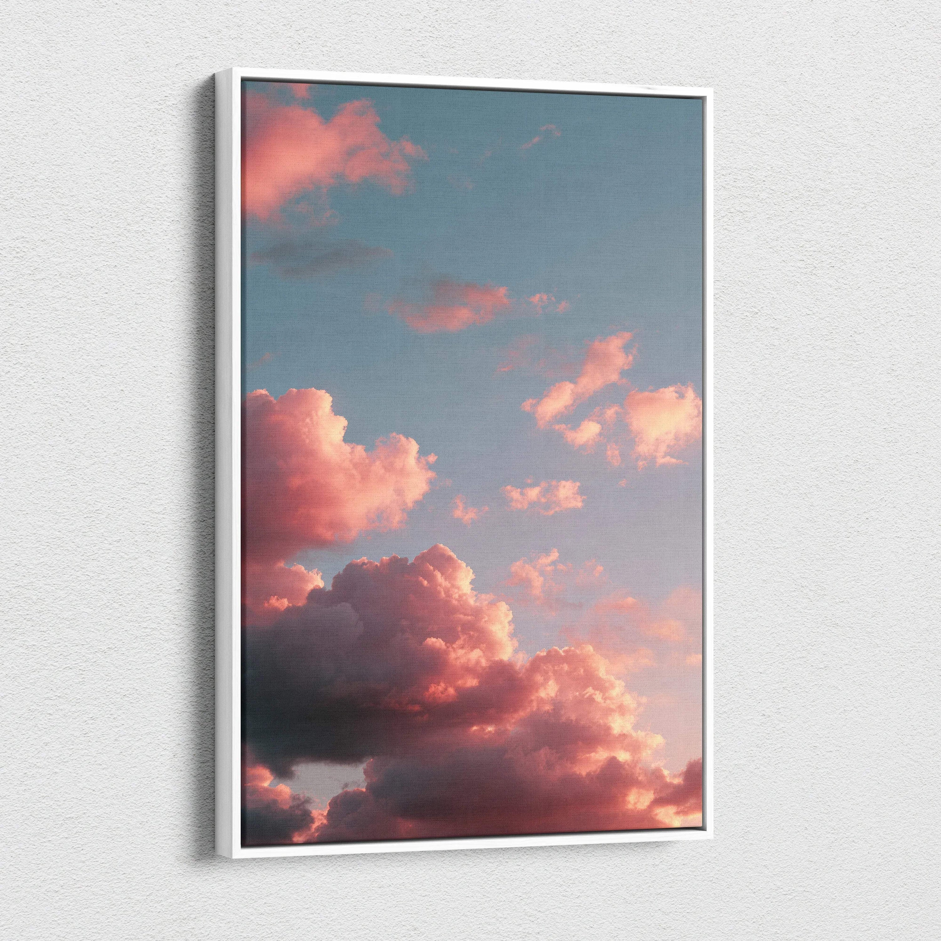 Vertical canvas wall art featuring vibrant pink and orange clouds at sunset against a blue sky.