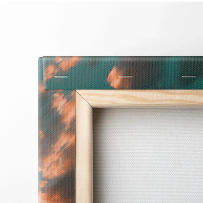 Close-up of canvas corner with wooden frame and abstract sunset mountain wall art texture.