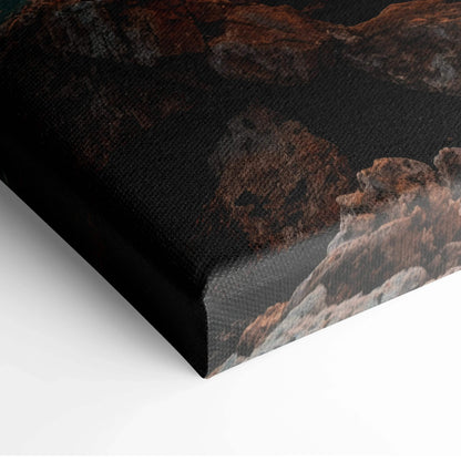 Close-up of canvas wall art corner with dark mountains and sunset tones.
