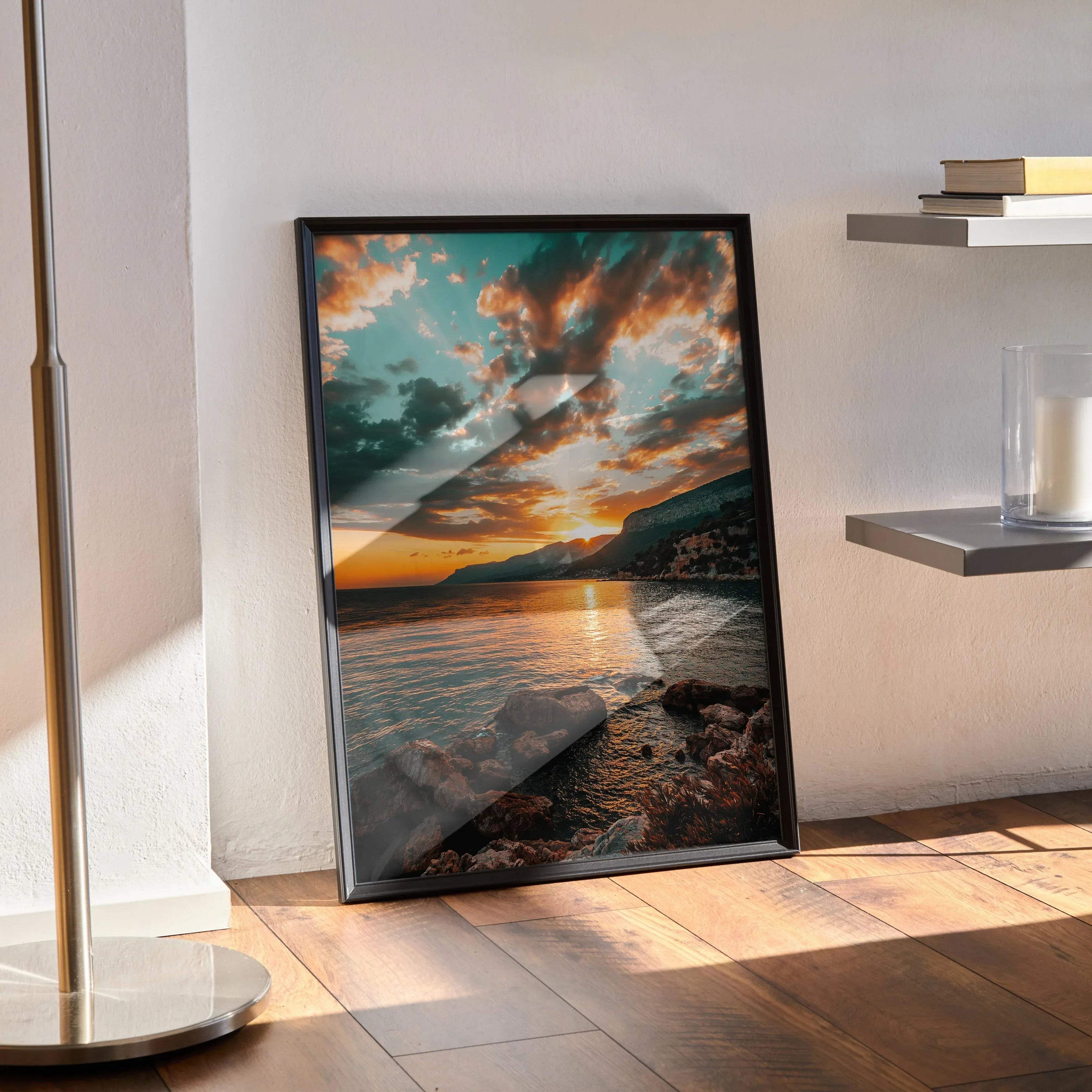 Vertical poster wall art featuring a serene beach sunset with vibrant orange and blue sky over calm water and rocky shore.
