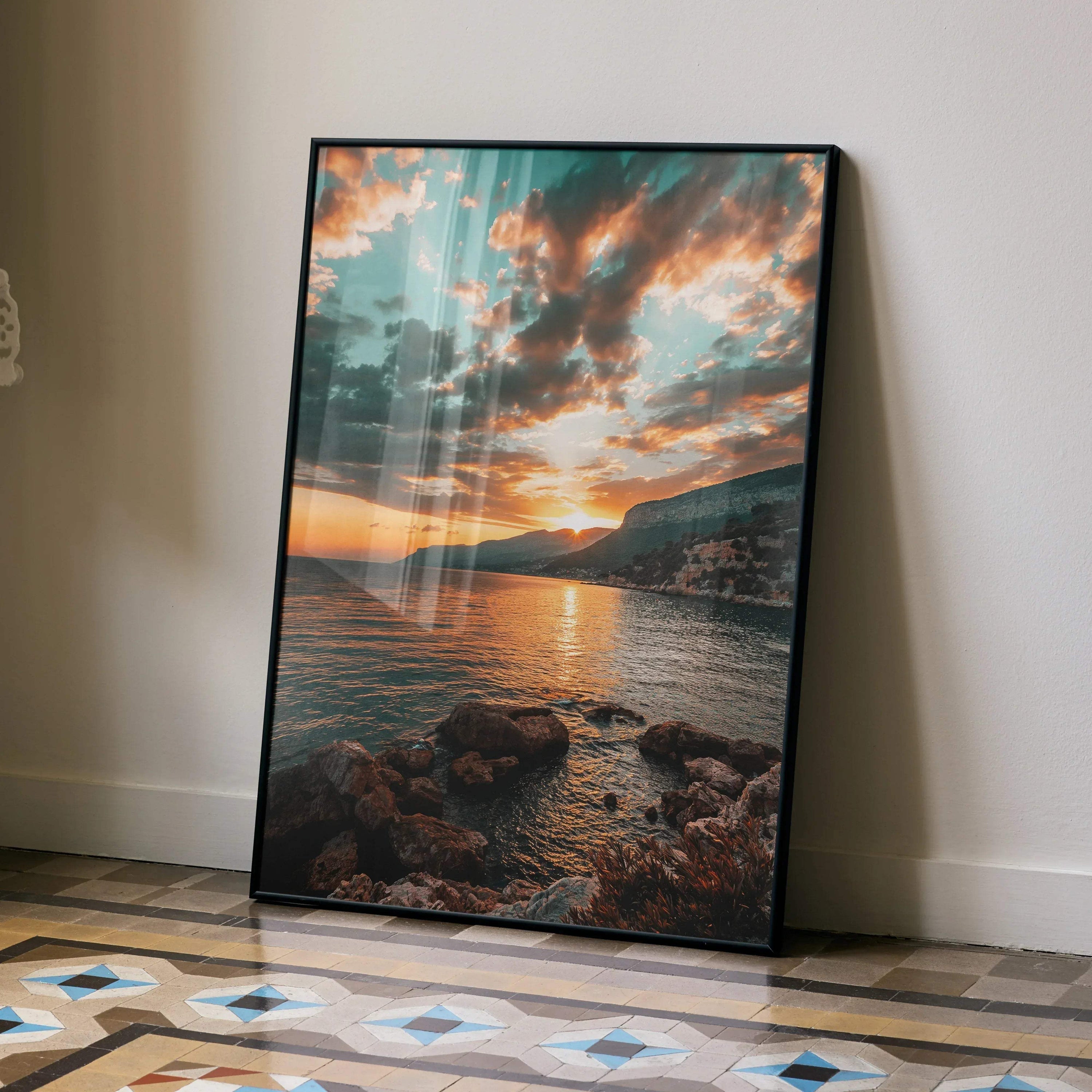 Vertical beach sunset poster with vibrant orange sky and rocky shoreline wall art.