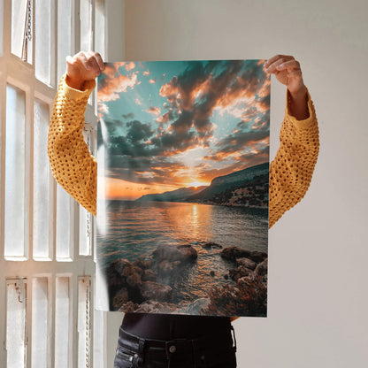 Serene beach sunset poster with vibrant sky and rocky shoreline wall art.