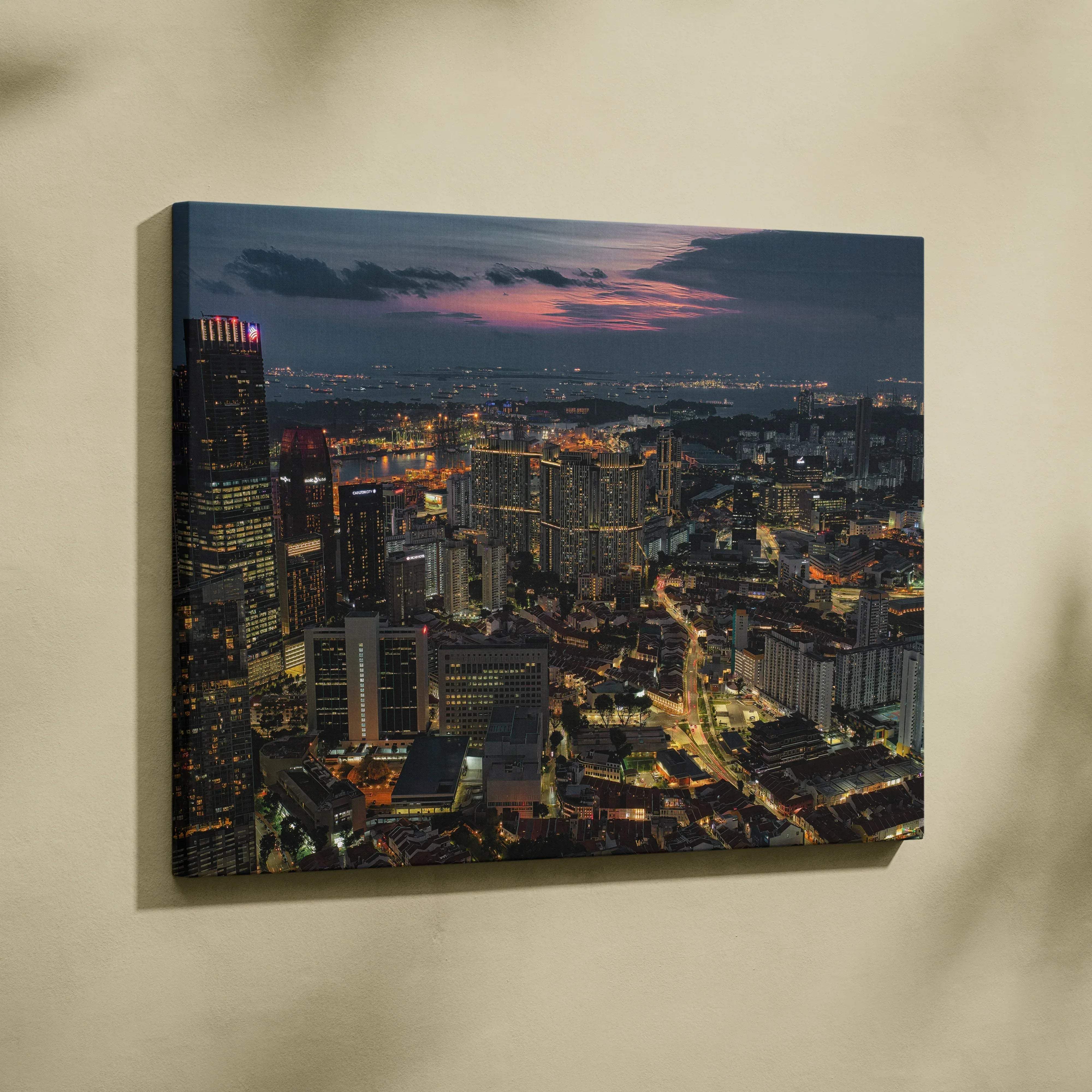 A rectangular canvas print of a vibrant urban night cityscape with illuminated skyscrapers and a pink purple dusk sky