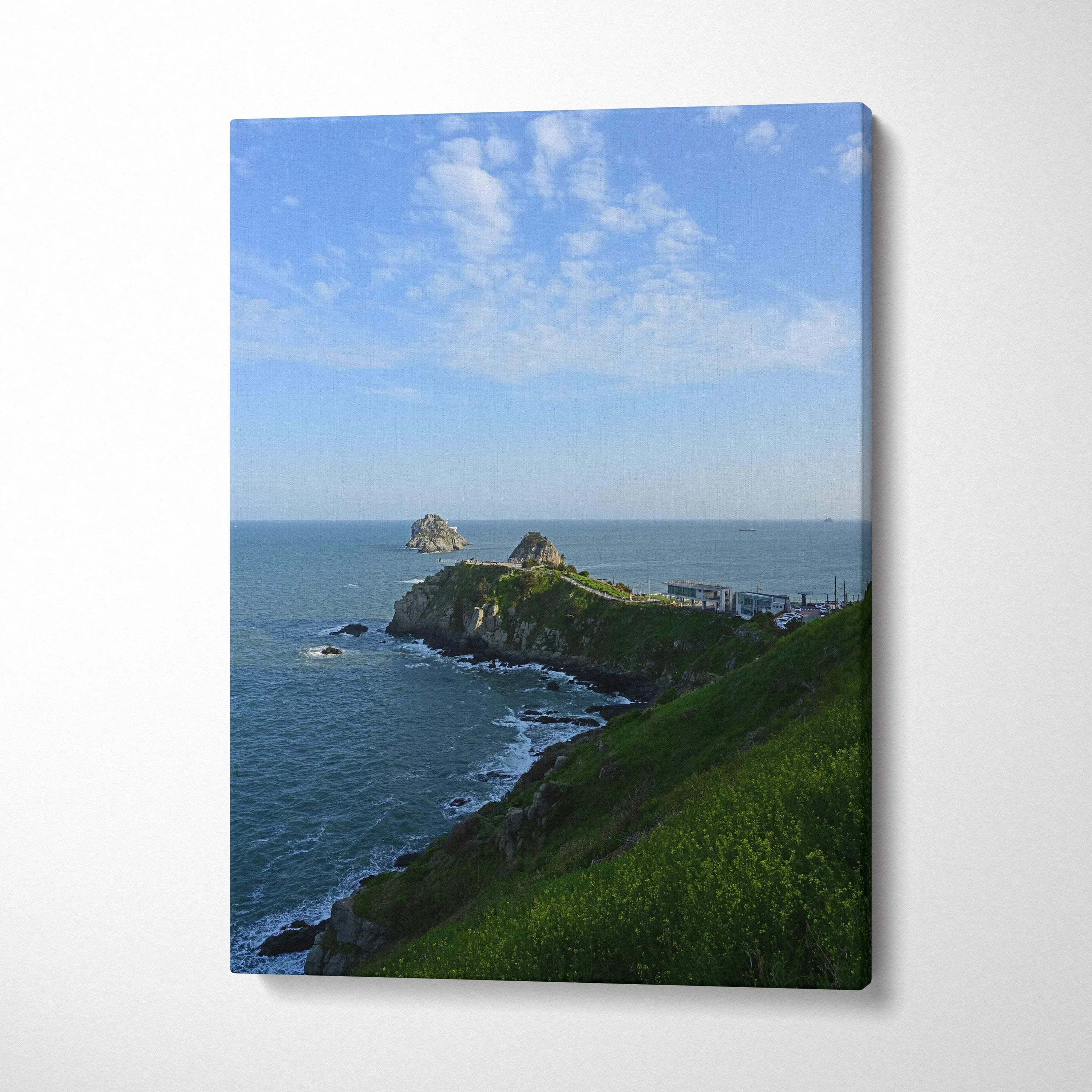Canvas wall art featuring a serene beach and majestic mountain landscape under a blue sky with scattered clouds.
