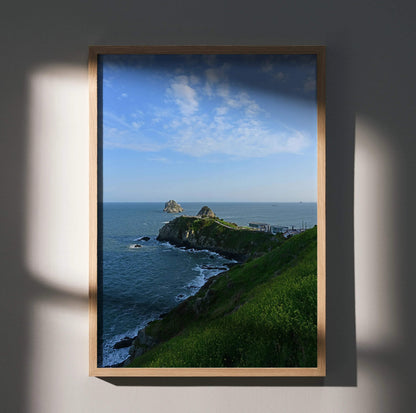 Vertical ocean waves art poster with rocky coastline and green hillside wall art.