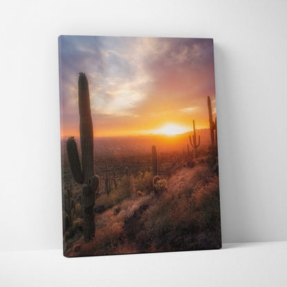 Vibrant desert sunset canvas wall art featuring tall cacti and glowing sky in warm hues.