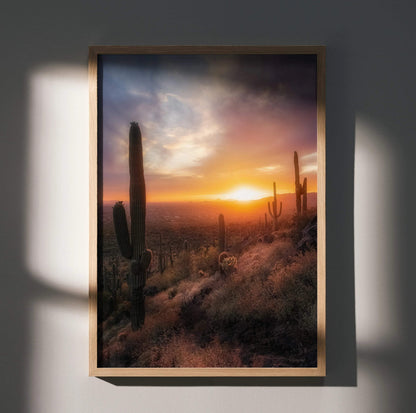 Desert sunset wall art poster with glowing sun and tall cacti in warm tones.
