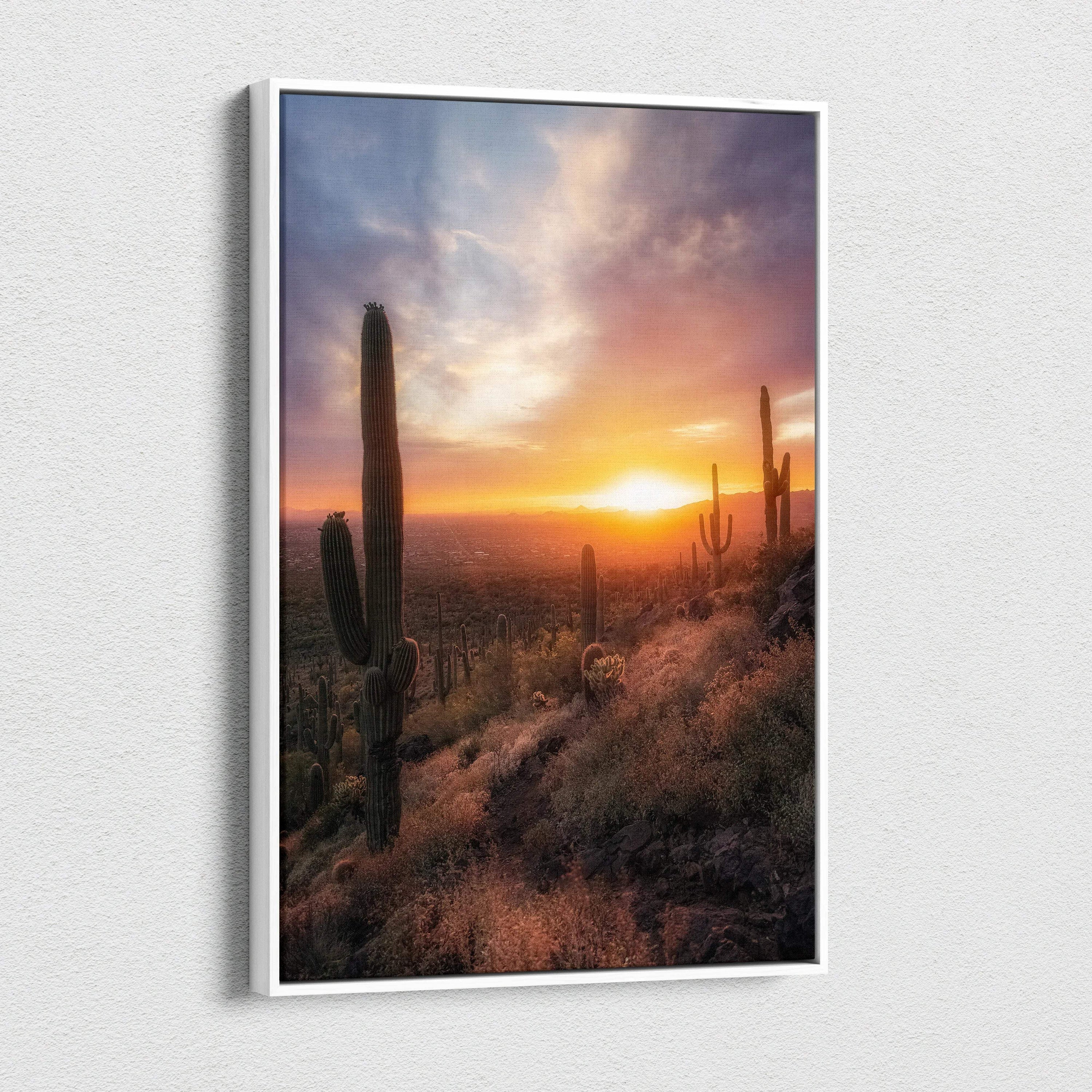 Vertical canvas wall art featuring a vibrant desert sunset with tall cacti and glowing sky.