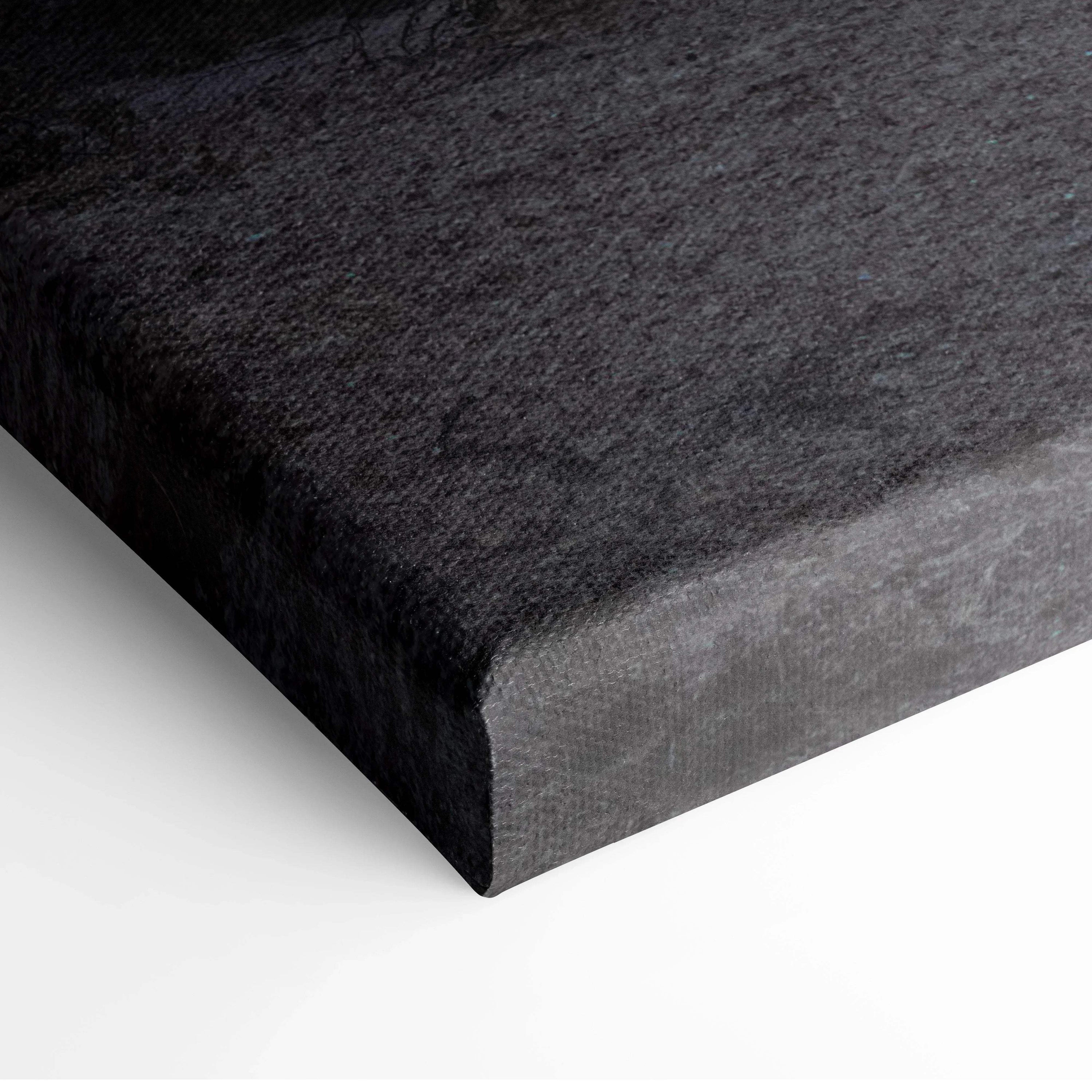 Close-up of black textured canvas wall art with visibly wrapped edges and smooth finish.
