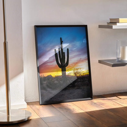 Vibrant desert sunset poster wall art with silhouetted cactus and colorful sky in vertical frame.