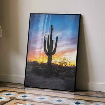 Desert cactus silhouette against vibrant sunset sky poster wall art with rich orange and blue tones.