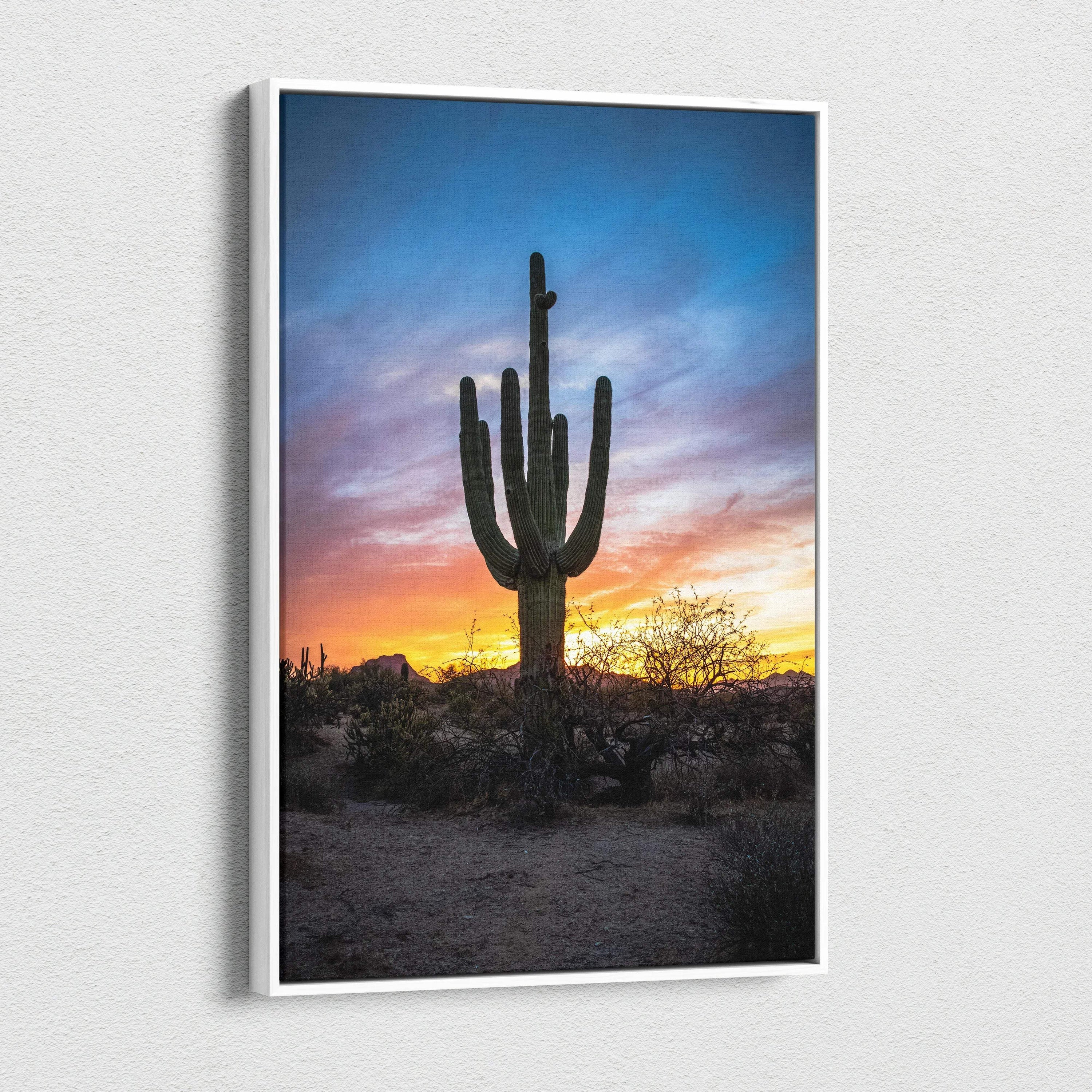 Vertical canvas wall art featuring a tall cactus silhouette against a colorful desert sunset sky.