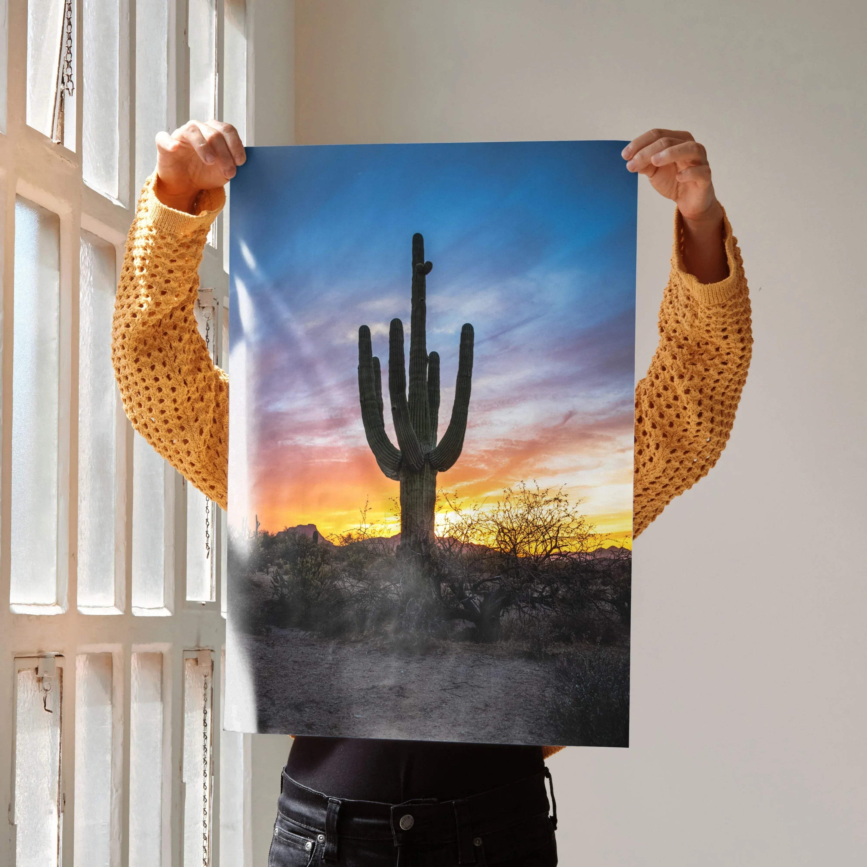 Vertical poster wall art featuring a silhouetted cactus against a vibrant desert sunset sky.