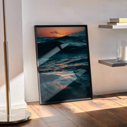 Ocean sunset with vibrant orange and blue hues in vertical wall art poster with black frame.