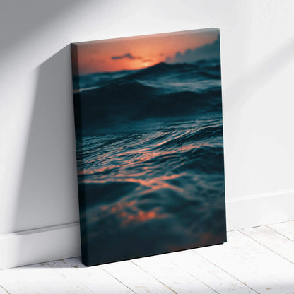 Ocean waves at sunset with deep blue and orange hues on canvas wall art.