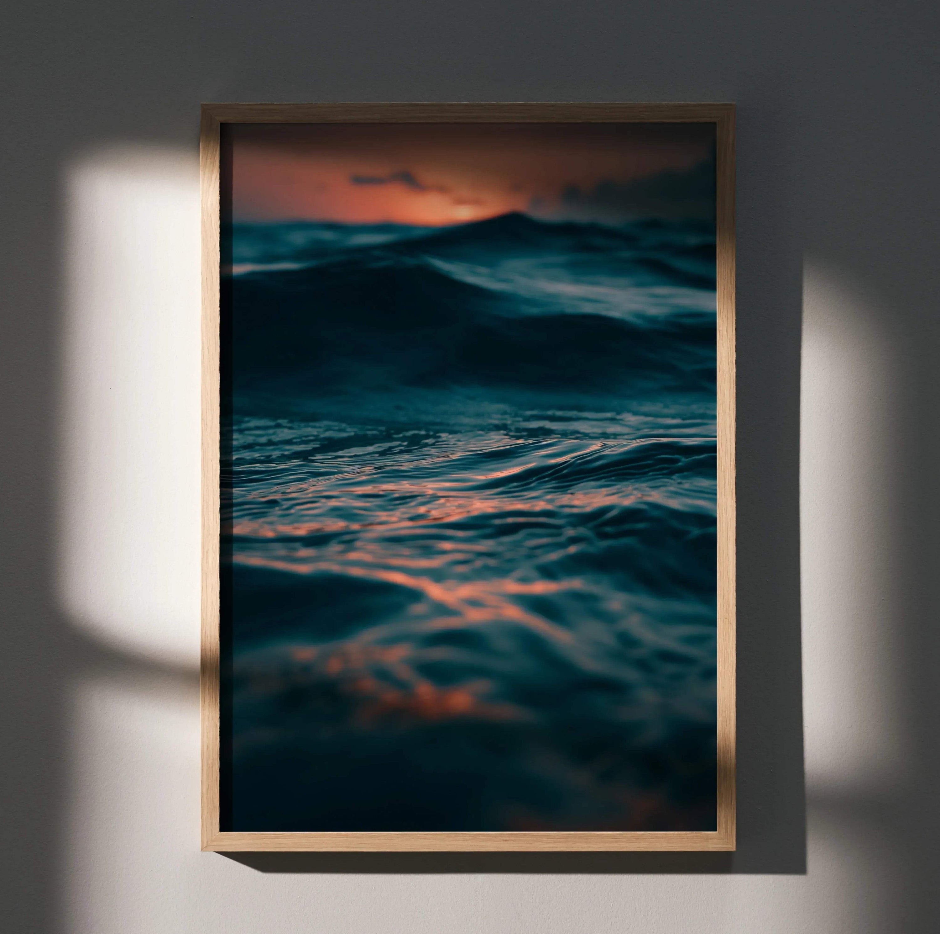 Ocean waves at sunset with deep blue and orange hues vertical wall art poster.