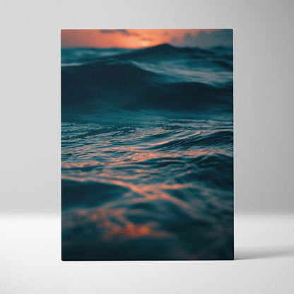 Canvas wall art featuring a deep blue ocean wave with a warm orange sunset reflection.