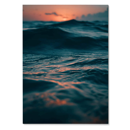 Vertical wall art poster of dark ocean waves with a glowing orange sunset sky background.