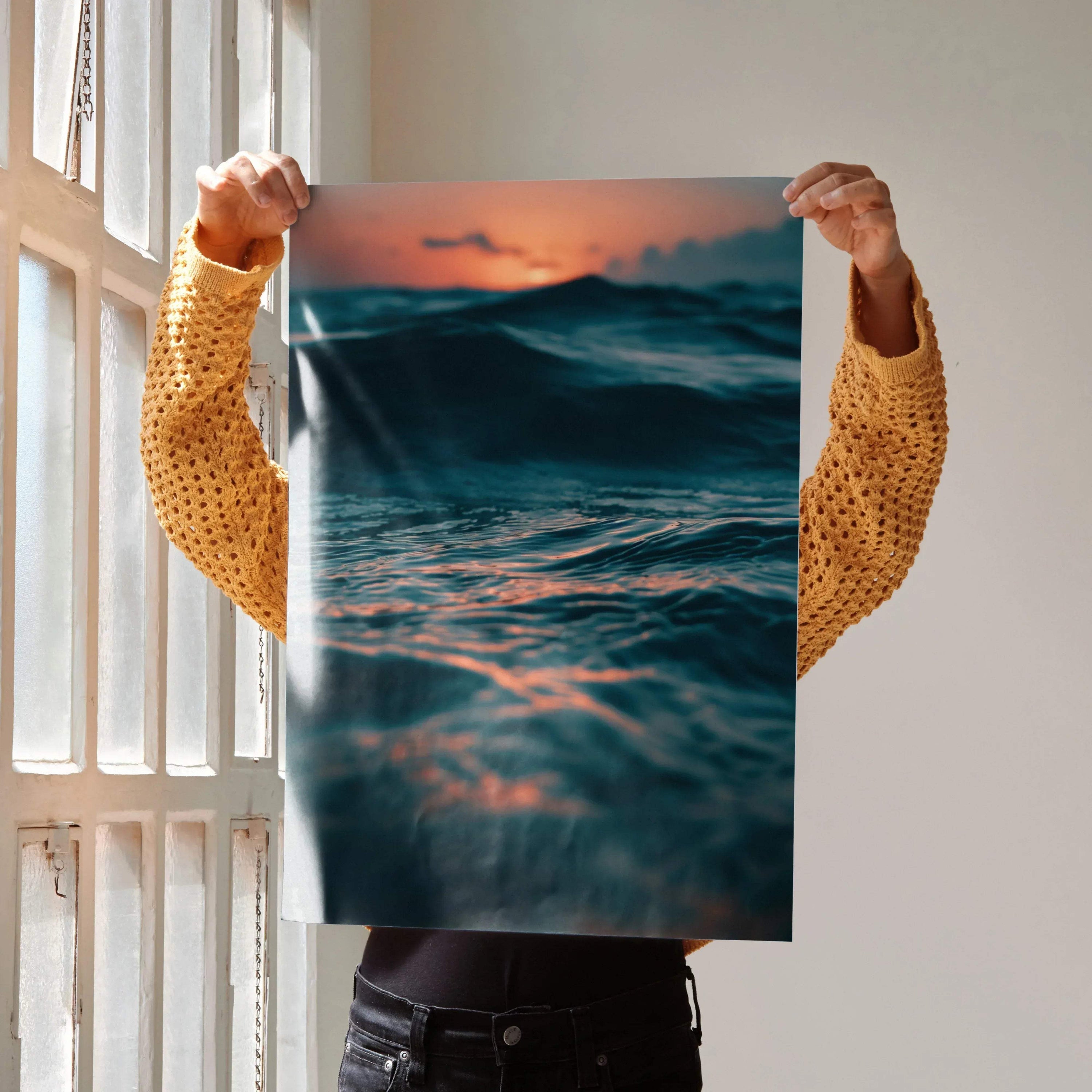 Ocean sunset wall art poster with dark waves under a vibrant orange sky.
