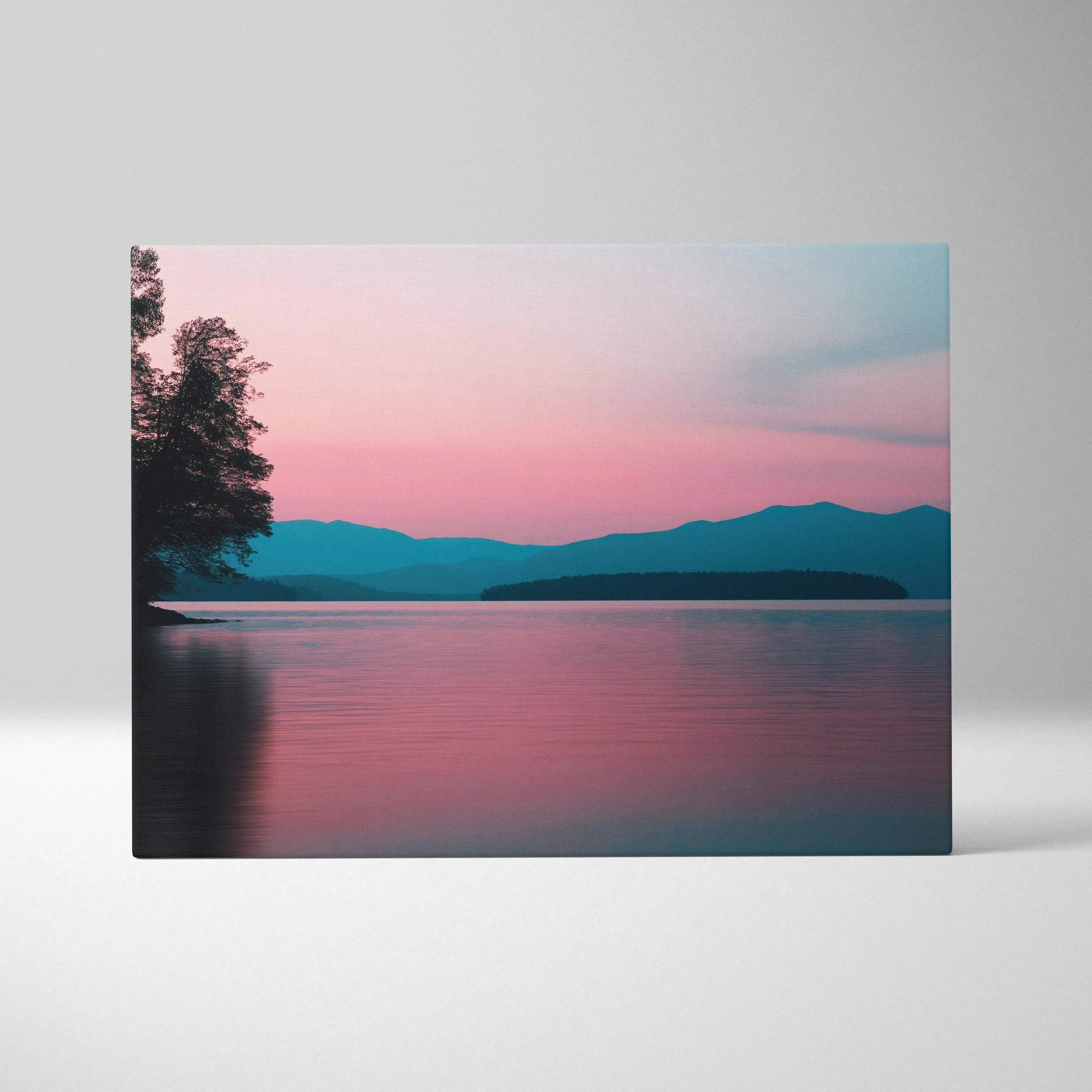 Canvas wall art of a serene lake at sunset with pink and blue skies and distant mountains.