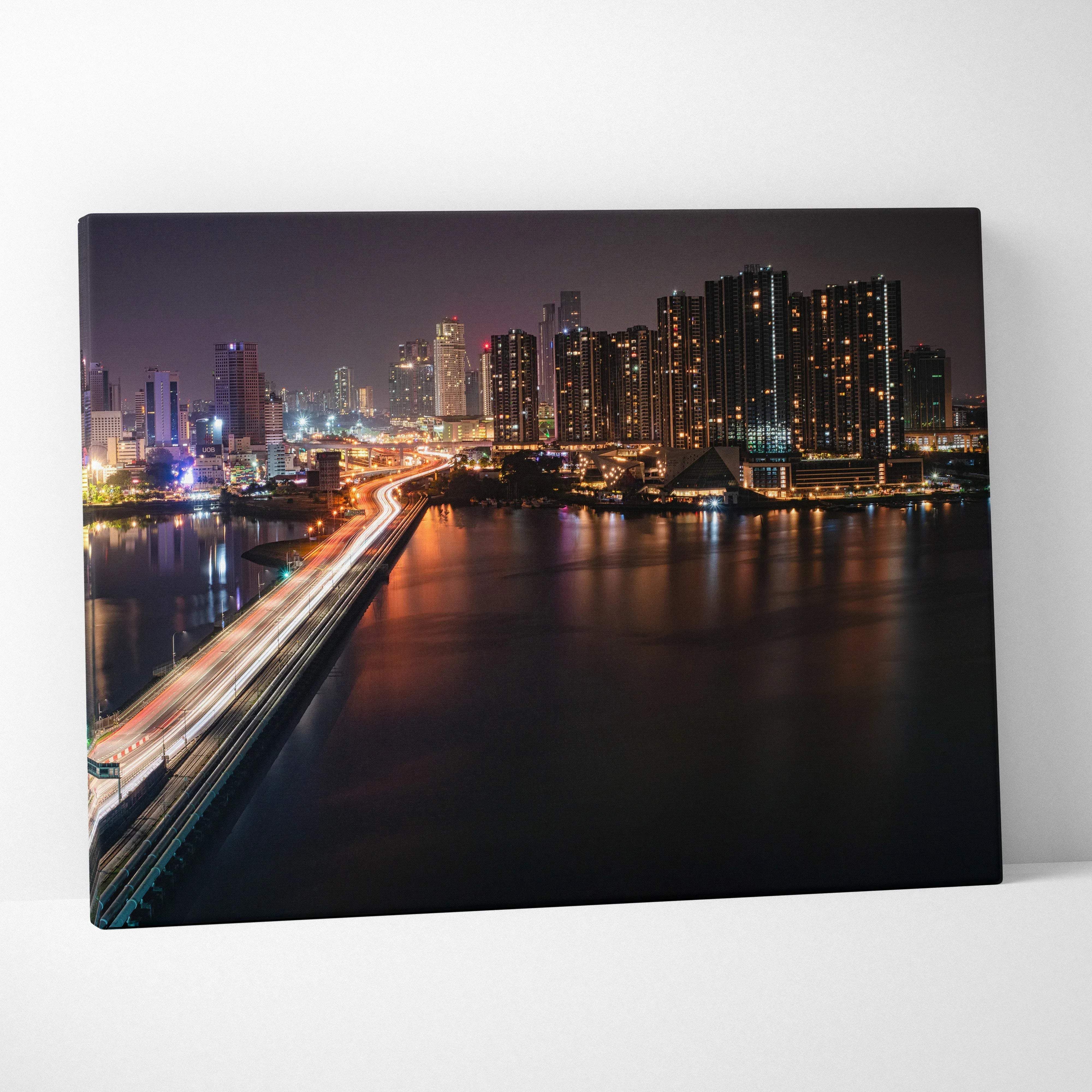 Modern urban nightscape city skyline canvas wall art with vibrant illuminated skyscrapers and glowing bridge over water