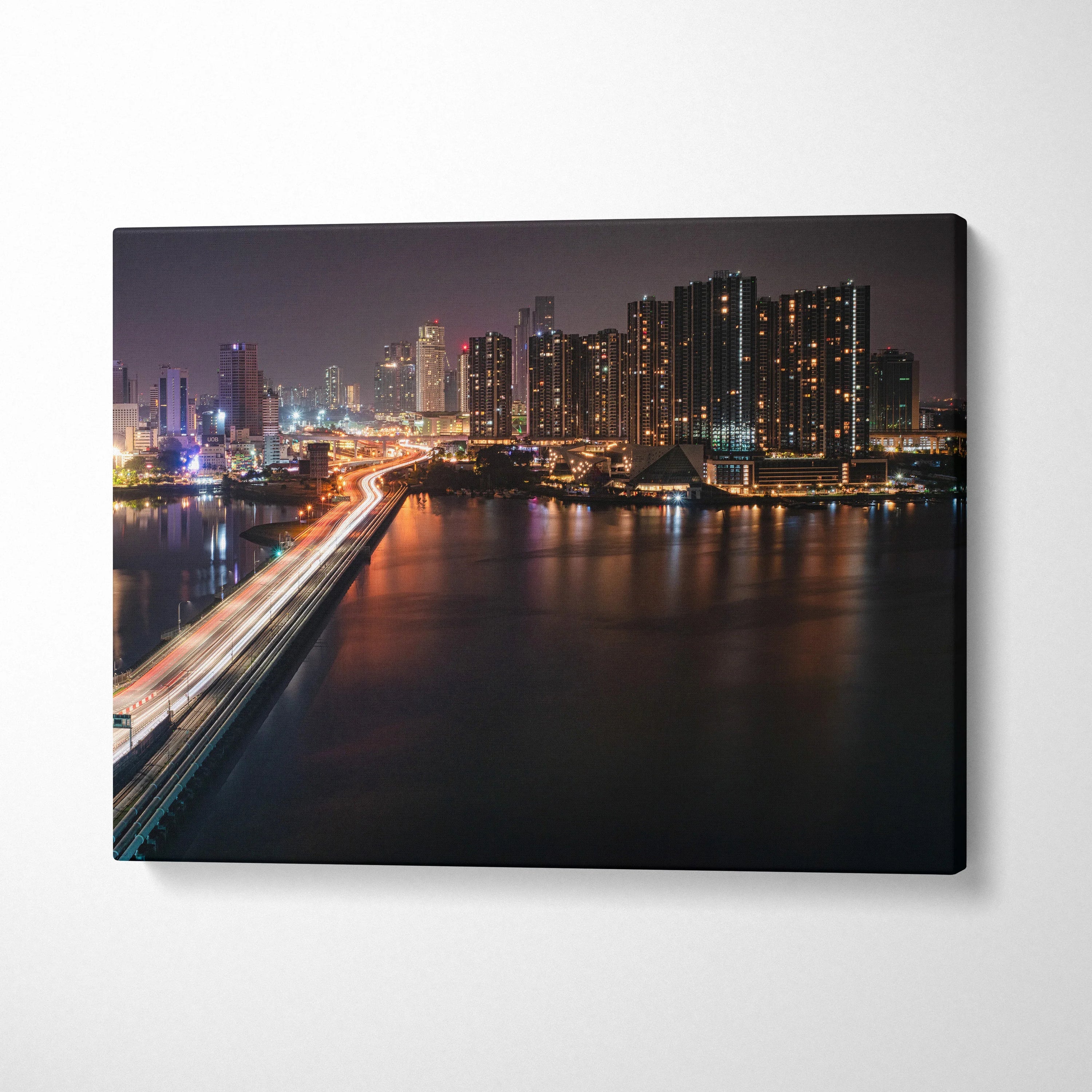 City skyline at night with illuminated buildings and light trails on a bridge on canvas wall art.