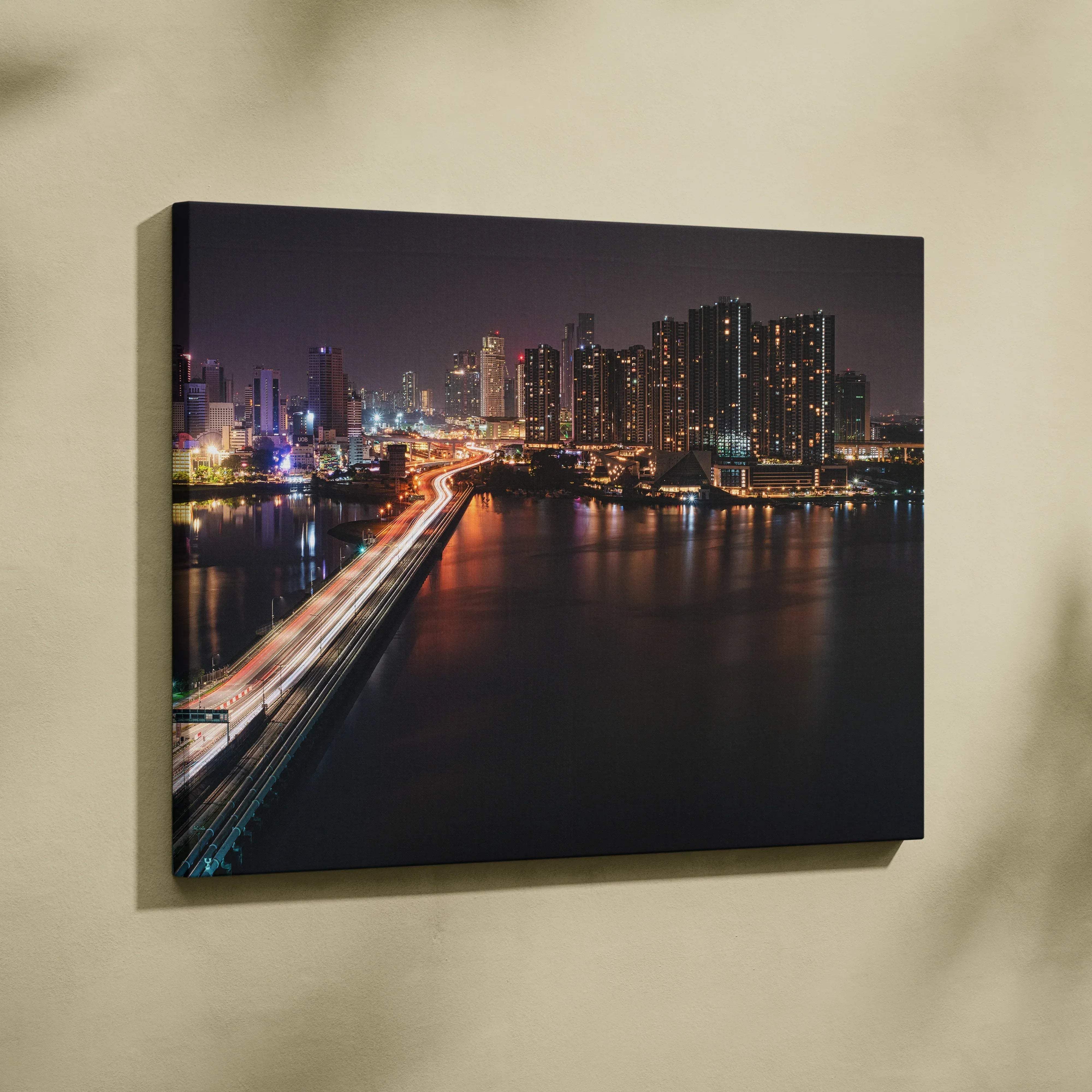 Modern urban nightscape canvas wall art featuring illuminated skyscrapers and a glowing bridge over water