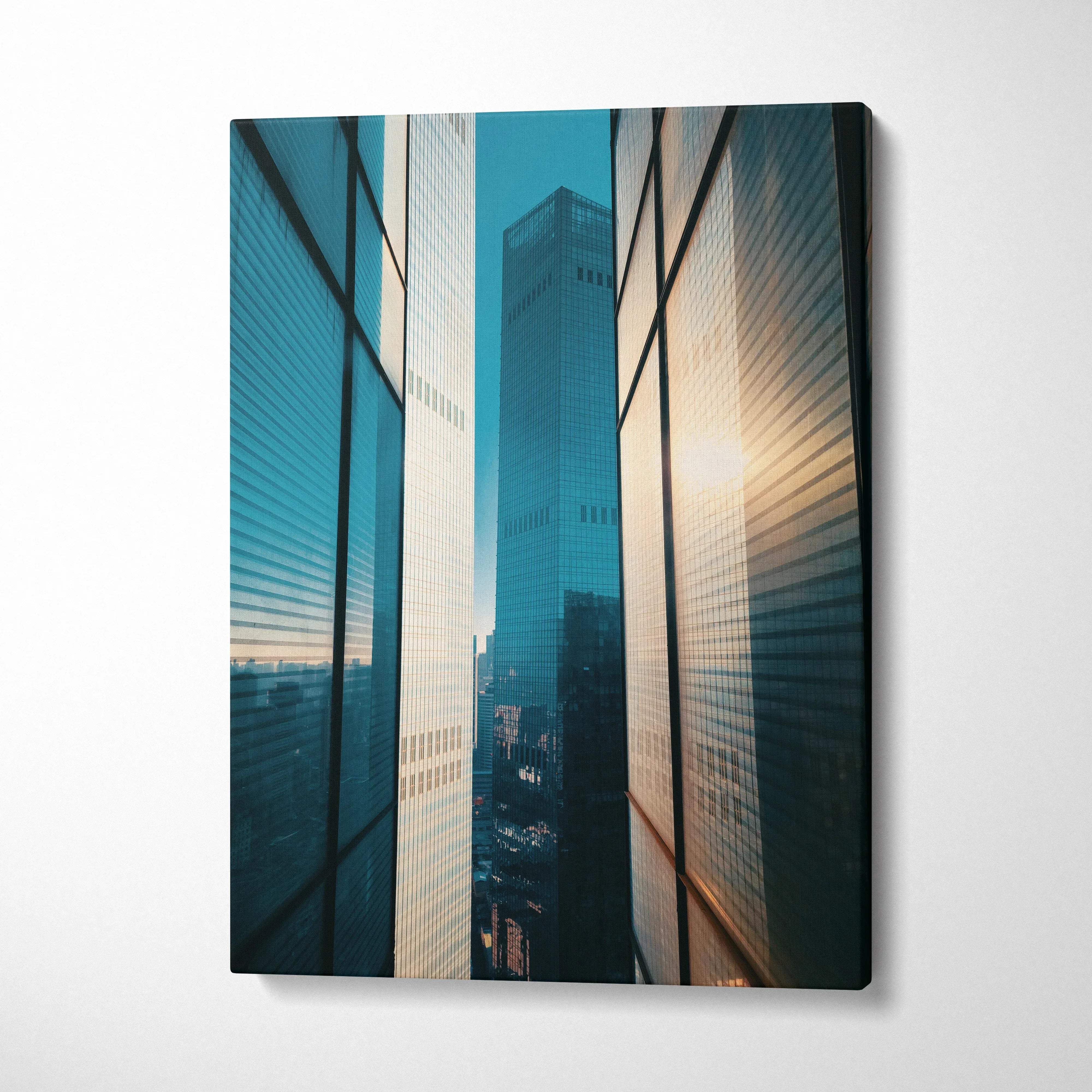 Vertical canvas wall art featuring high-resolution urban skyscraper buildings with reflective glass facades at sunset.
