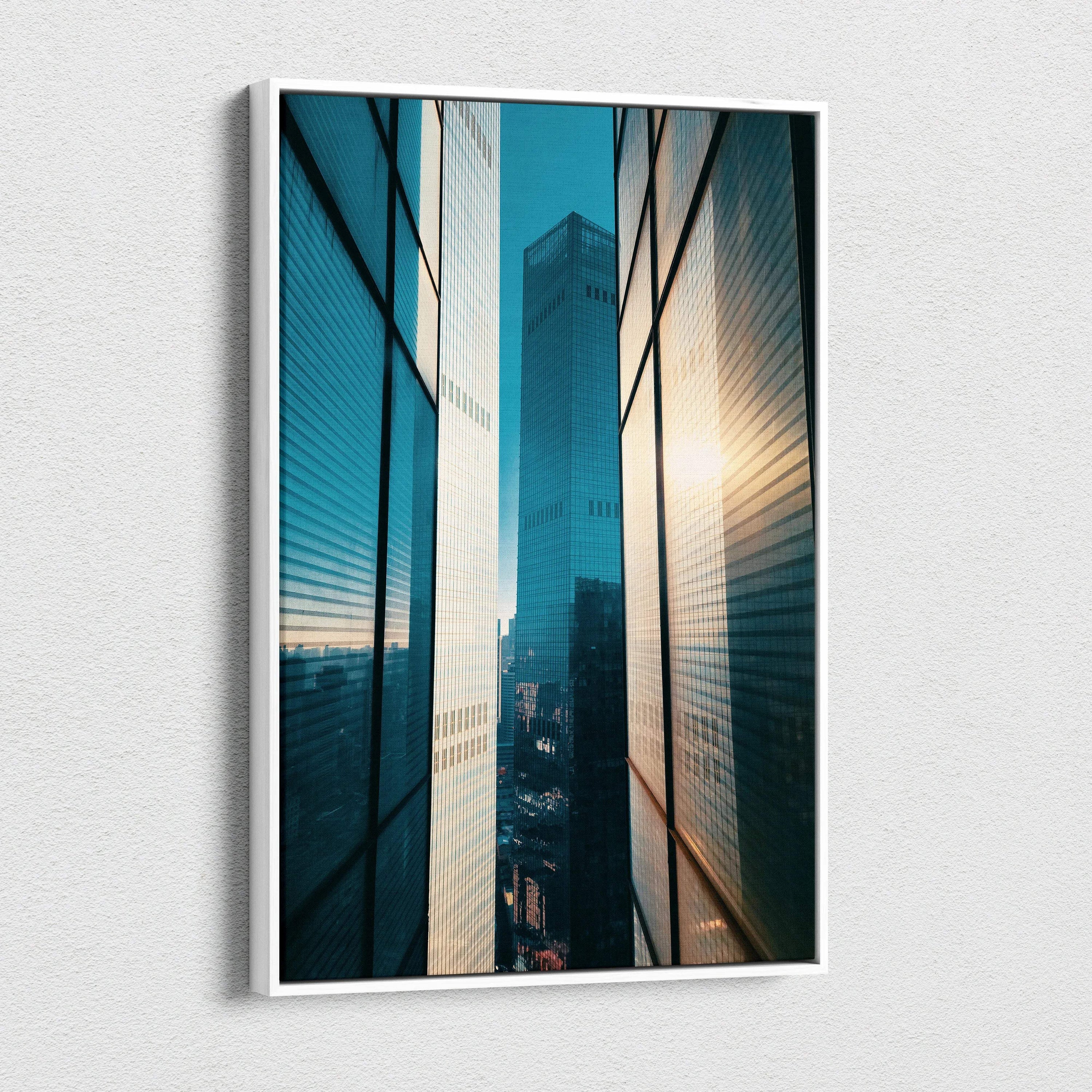 Vertical canvas wall art depicting high-resolution urban buildings with sunlit reflections.