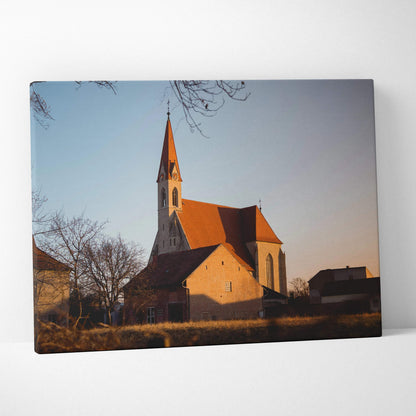 Canvas wall art featuring a church building with a tall steeple at sunset.