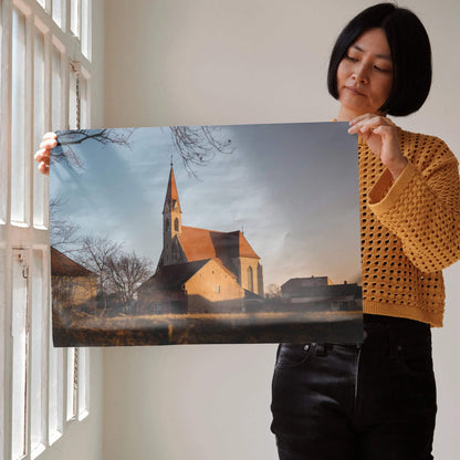 Woman holding serene nature faith landscape wall art poster featuring church steeple at sunset with soft clouds.